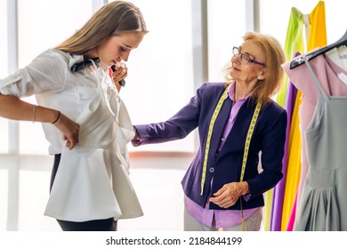 Portrait Of Young Beautiful Pretty Owner Business Woman Fashion Designer Stylish Sitting And Working.Attractive Senior Woman Designer Working With Colorful Fabrics At Fashion Design Workshop Studio