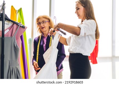 Portrait Of Young Beautiful Pretty Owner Business Woman Fashion Designer Stylish Sitting And Working.Attractive Senior Woman Designer Working With Colorful Fabrics At Fashion Design Workshop Studio