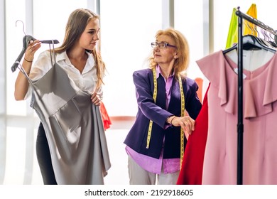 Portrait Of Young Beautiful Pretty Owner Business Woman Fashion Designer Stylish Sitting And Working.Attractive Senior Woman Designer Working With Colorful Fabrics At Fashion Design Workshop Studio