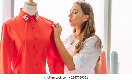 Portrait of young beautiful pretty owner business woman fashion designer stylish sitting and working.Attractive young designer girl use desktop conputer and colorful fabrics at fashion workshop studio - Powered by Shutterstock