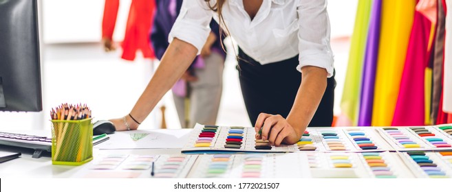 Portrait of young beautiful pretty woman fashion designer stylish stand and working with color textile samples.Attractive  senior woman working with mannequins and colorful fabrics at fashion studio - Powered by Shutterstock