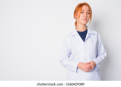 Portrait of young beautiful redhead woman doctor