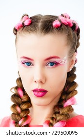Portrait of the young beautiful sexy woman, hairstyle with braids, and a make-up. Soft focus