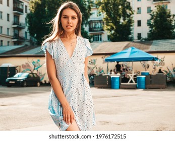 Portrait of young beautiful smiling  woman in trendy summer sundress.Sexy carefree woman posing on the street background at sunset. Positive model outdoors  - Shutterstock ID 1976172515