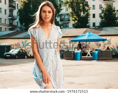 Portrait of young beautiful smiling  woman in trendy summer sundress.Sexy carefree woman posing on the street background at sunset. Positive model outdoors 