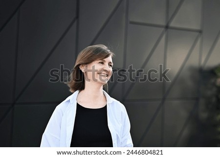 Similar – Young pretty woman in a pink blazer stands in front of an orange wall