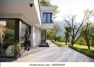 Portrait Of A Young Beautiful Successful Woman In The Doorway Of Her Luxury Home Villa