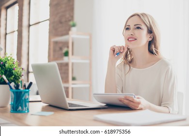 Portrait Of Young Beautiful Thoughtful Lady Sitting At The Table Working With Laptop On Writing Down New Ideas