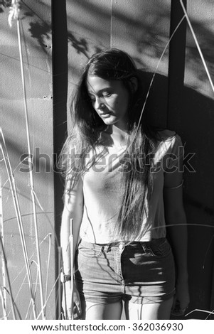 Similar – barefoot young woman sitting barefoot in a window frame