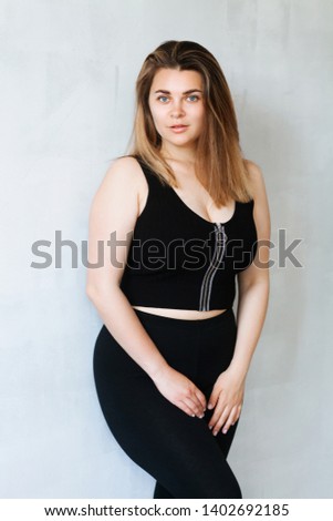 Portrait of young beautiful woman in black outfit 