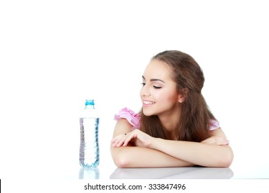 Portrait Of Young Beautiful Woman With Bottle Of Mineral Water On White