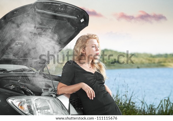 portrait
of young beautiful woman with broken car
aside