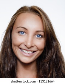 Portrait Of A Young Beautiful Woman With Brown Hair And Blue Eyes Smiling