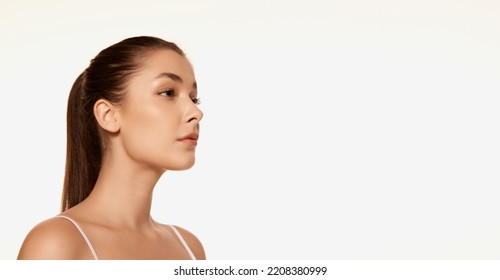 Portrait Of Young Beautiful Woman With Clear Spotless Skin Isolated Over White Background. Cosmetology Treatment. Flyer. Concept Of Beauty, Skin Care, Plastic Surgery, Anti Aging Care