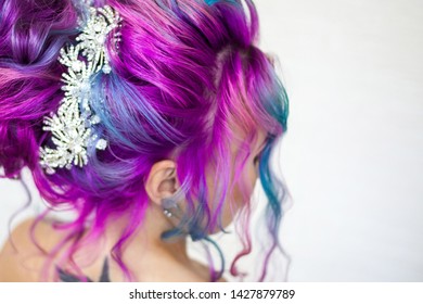 Portrait young beautiful woman and colored hair  Bright shades blue   purple  gradient hair  Elegant hairstyle in the hairstyle salon