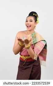 Portrait Young beautiful woman dress up thai northeastern region, standing to presenting open palm to  copy space for insert advertise product with two hand gesture on white background