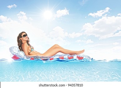 portrait of young beautiful woman hanging out on air mattress
