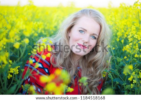 Portrait of a young beautiful woman on a flower field