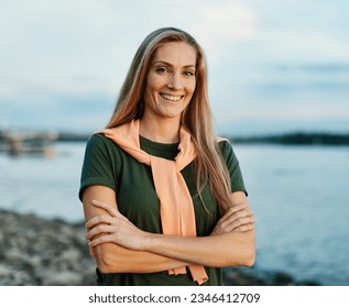 Portrait of a young beautiful woman outdoors. Happy woman outside by a river
