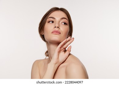 Portrait of young beautiful woman with perfect smooth skin isolated over white background. Concept of natural beauty, plastic surgery, cosmetology, cosmetics, skin care. Copy space for ad - Shutterstock ID 2228044097