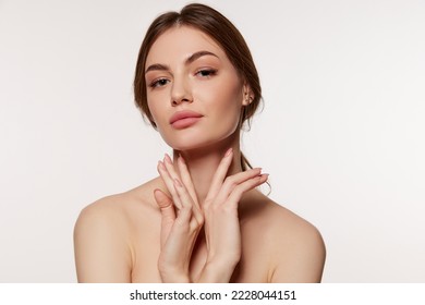 Portrait of young beautiful woman with perfect smooth skin isolated over white background. Facebuilding. Concept of natural beauty, plastic surgery, cosmetology, cosmetics, skin care - Shutterstock ID 2228044151