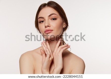 Photo of Portrait of young beautiful woman with perfect smooth skin isolated over white background. Facebuilding. Concept of natural beauty, plastic surgery, cosmetology, cosmetics, skin care