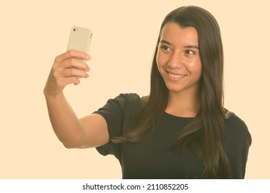 Portrait of young beautiful woman shot against studio background - Shutterstock ID 2110852205