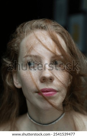 Similar – Hopeful Portrait of a Young Woman at the Window