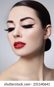 Portrait Of Young Beautiful Woman With Stylish Makeup. False Eyelashes, Black Eyeliner And Red Lips