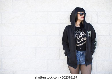 Portrait Of A Young Beautiful Woman In A Urban Background Wearing Black Clothing