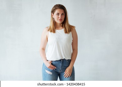 Portrait of young beautiful woman in white shirt and jeans 
