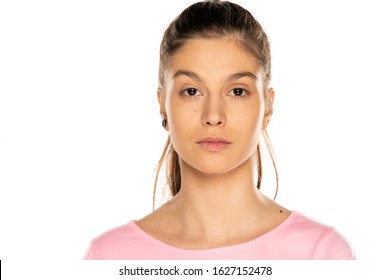 Portrait of young beautiful woman without makeup, and with moles on white background