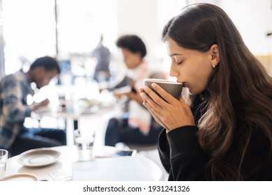 Portrait Of A Young Beautiful Women Drinking Coffee In Cafe