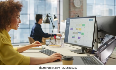 Portrait of Young Biracial Woman Working on a Computer. Female Team Lead Checking her Calender to Schedule Meetings for Team Members Development. - Shutterstock ID 2216815769