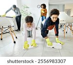 Portrait of a young black family cleaning house, family doing chores at home