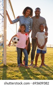 Portrait Of A Young Black Family Next To A Football Goal