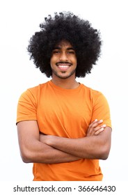 Portrait Of A Young Black Guy Smiling With Arms Crossed Against White Background