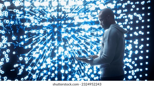 Portrait of Young Black Man Working on Laptop, Looking at Big Digital Screen Displaying Neural Network Visualisation in 3D. Professional Data Specialist Analysing User Information Concept.