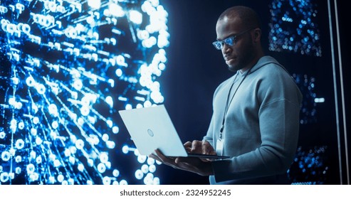 Portrait of Young Black Man Working on Laptop Computer, Looking at Big Digital Screen Displaying Neural Network Visualisation in 3D. Professional Data Specialist Analysing User Information