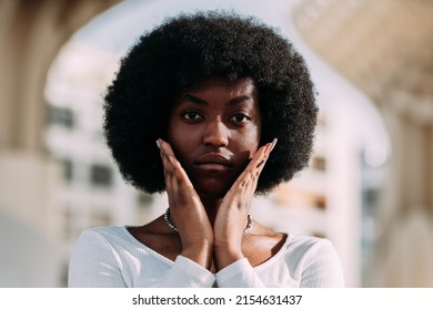 Portrait Of A Young Black Woman Activist With Afro Hair Gesturing With Her Hands In A V Shape. Horizontal