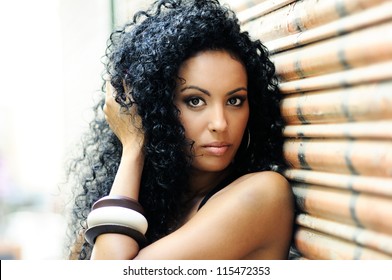 Portrait of a young black woman, model of fashion in urban background