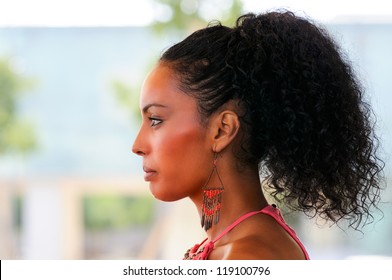 Portrait Of A Young Black Woman Profile, Model Of Fashion, With Pink Dress And Earrings. Afro Hairstyle