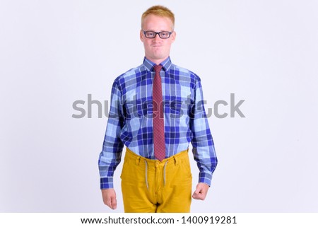 Portrait of young blonde businessman with puffed cheeks
