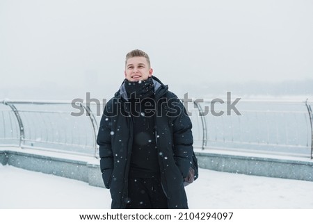 Portrait of young blonde guy Nordic appearance, lifestyle of young people. Handsome guy close up, winter day thinking about something