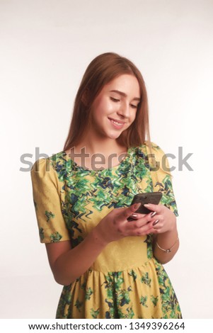 Portrait of young blonde lady isolated white background happy smiling cheerful posing with phone chating sms looking aside