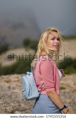 Portrait of young blonde model in Spain Mountains