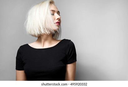 Portrait of a young blonde woman with  red lipstick on her lips in a short black T-shirt - Powered by Shutterstock