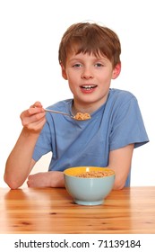 Portrait of a young boy eating cereals isolated on white background