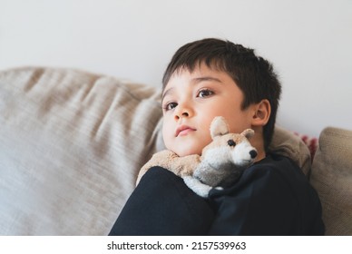 Portrait Young Boy Looking Deep In Thought,School Kid Looking Out With Thinking Face. Child With Curious Face Sitting Alone On Sofa. Positive Child Resting Watching TV In Living Room 