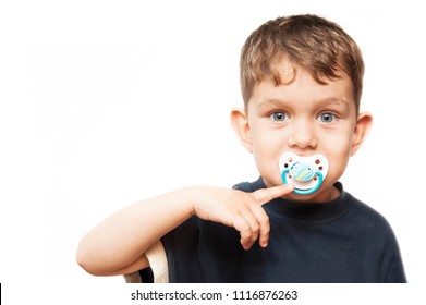 Portrait of a young boy on a white background with a dummy - Baby Pacifier in his mouth. He smiles because he is too late to use a dummy because he has been three years old. Isolated